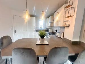 a kitchen with a table and chairs with a plant on it at Ruby Place by Blue Skies Stays in Hartlepool