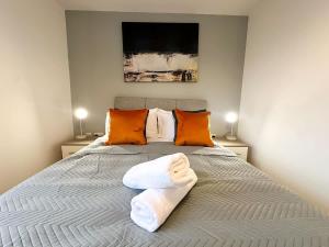 a bedroom with a bed with two towels on it at Edison House by Blue Skies Stays in Stockton-on-Tees