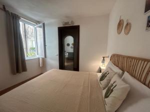 a bedroom with a large bed and a window at Vicolo 35 Apartments in Trapani