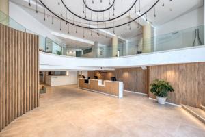 a large lobby with a large clock on the ceiling at Ohtels Gran Hotel Almeria in Almería