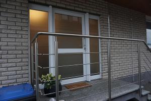 a sliding glass door with a plant on a porch at Work und Relax Appartment in Horn-Bad Meinberg