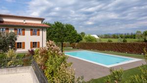 a swimming pool in a yard next to a house at Alba - Borgo Le Tese in Rivoltella