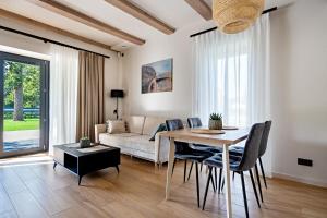 a living room with a table and a couch at ApartHouse 45B in Radomierzyce