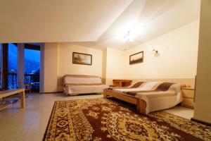 a bedroom with two beds and a rug at Pokoje U SABI in Wisła