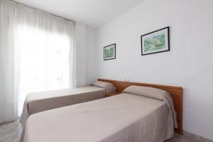 Posteľ alebo postele v izbe v ubytovaní Rentalmar Aventura