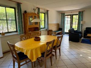 a dining room with a yellow table and chairs at Buitenplaats 105 in Callantsoog