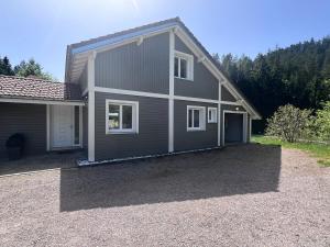 une maison avec une allée de gravier devant elle dans l'établissement Chalet Vertpheny Spa & Terrasse à 500m du Lac de Gérardmer, à Gérardmer
