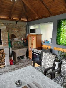 a kitchen with a table and a stove top oven at Home in Sarajevo in Doglodi