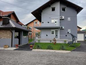 a house with a playground in front of it at Home in Sarajevo in Doglodi