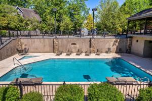 a large swimming pool with lounge chairs at The Wacky Woodpecker in Pigeon Forge