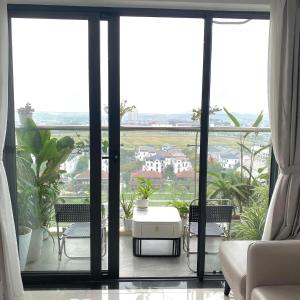 a living room with a view of a city at Nothingness House in Thôn Văn Dương