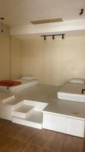 two beds in a room with white cabinets at Serene Japandi Ryokan - Green Staycay in Jakarta in Jakarta +23 photos