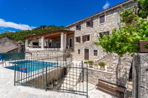 a stone house with a swimming pool in front of it at Private pool villa - Meditteranean peace in Slano