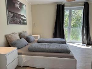 a bedroom with two beds and a large window at Ferienhaus Norderdiek in Harrislee +10 photos