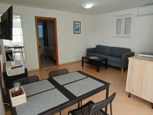 a living room with a table and chairs and a couch at Vanda Seafront Superior in Cavtat