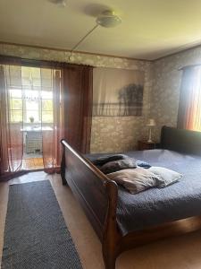 a bedroom with a bed and a window at Trehornahult Lillstugan in Burseryd +42 photos