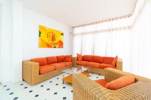 a living room with two couches and a table at Villa Nico - By Aloha Palma in Águilas