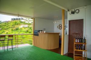 a room with a balcony with a bar with a view at The View Homestay Monjam เดอะวิว โฮมสเตย์ม่อนแจ่ม in Mon Jam