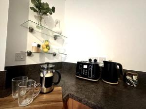 a kitchen counter with appliances on a counter top at Alma House by Blue Skies Stays in Hartlepool