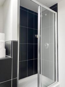 a shower with a glass door in a bathroom at Duxford House by Blue Skies Stays in Middlesbrough