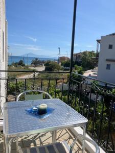 ein Tisch mit einem Teller Essen auf einem Balkon in der Unterkunft Blue Sea Studios in Limenaria