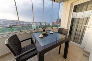 a dining table and chairs in a room with a window at Belya Apart Hotel in Sancak