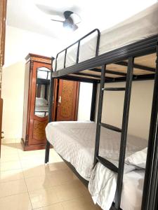 a bedroom with two bunk beds in a room at SF Homey Galaxy in Cikundul