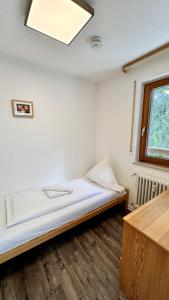a bed in a room with a window at Waldtwin 1 Titisee (W11) + Hochschwarzwald Card in Titisee-Neustadt