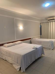a room with two beds in a room at Hotel Eduardus in Palmas