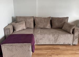 a brown couch with pillows in a living room at Apartament Leska, #Rodzinny#FV#24h# in Rzeszów
