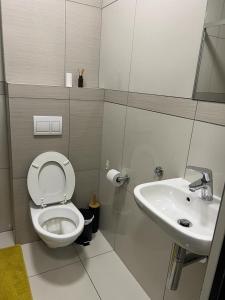 a bathroom with a toilet and a sink at Casa do Dylan in Khomas Region +10 photos
