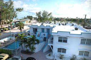 an aerial view of a white house with a swimming pool at Alamanda Villas on Holmes Beach in Holmes Beach