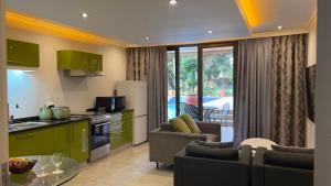 a kitchen and living room with green cabinets at 27A on Angus in Johannesburg