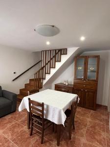 a dining room with a table and a staircase at Casa Vacanze da Melina in Taranto