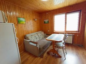 a room with a table and a bed in a room at Котедж in Yaremche