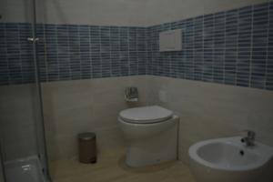 a bathroom with a toilet and a sink at Grottammare Summer Apartment in Grottammare