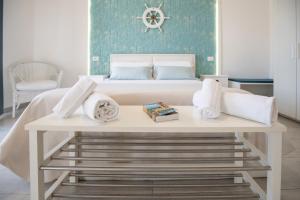 a bed with a table with towels on it at Catania Over Time - Tourist Rooms in Catania