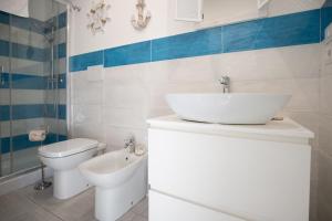 a bathroom with a sink and a toilet at Catania Over Time - Tourist Rooms in Catania