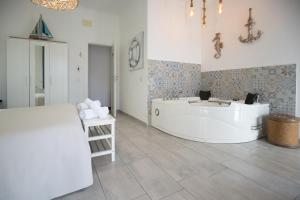 a bathroom with a white tub and a sink at Catania Over Time - Tourist Rooms in Catania