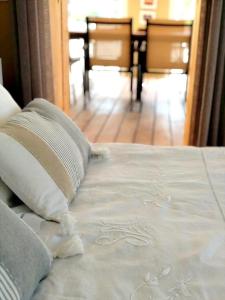 a bed with two pillows on top of it at maison d'hôtes 2 personnes les deux esprits libres in Claira +28 photos