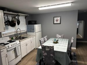 a kitchen with a table and a stove and a sink at Atlantic Breeze Motel & Apartments in Ocean City