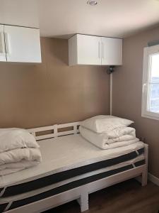 two beds in a room with white cabinets at Ossau Du Lit in Gère-Belesten +10 photos