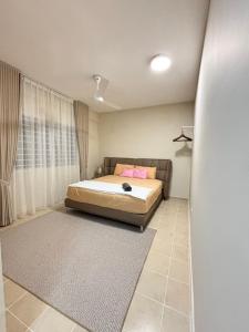 a bedroom with a bed and a rug at Ruhani Guesthouse KL Setapak Muji Style in Kuala Lumpur