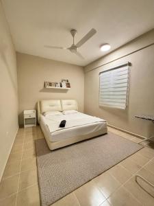 a bedroom with a bed and a ceiling fan at Ruhani Guesthouse KL Setapak Muji Style in Kuala Lumpur