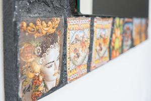 a row of paintings of a woman with a crown at Catania Over Time - Tourist Rooms in Catania