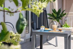 a table with a plate of food on a patio at Catania Over Time - Tourist Rooms in Catania