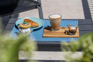 a table with two glasses of coffee and a plate of food at Catania Over Time - Tourist Rooms in Catania