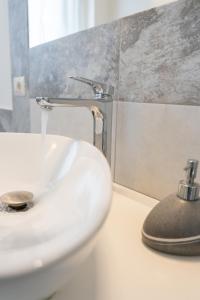 a bathroom sink with water running from a faucet at Catania Over Time - Tourist Rooms in Catania