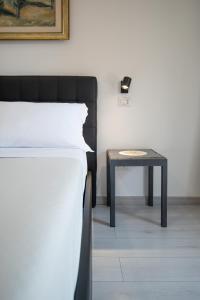 a bed and a table in a room at Catania Over Time - Tourist Rooms in Catania