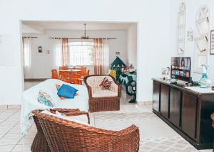 a living room with a couch and chairs at Pousada Praia do Sonho in Itanhaém